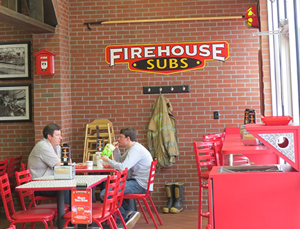 Photo of two men dining inside of a restaurant location